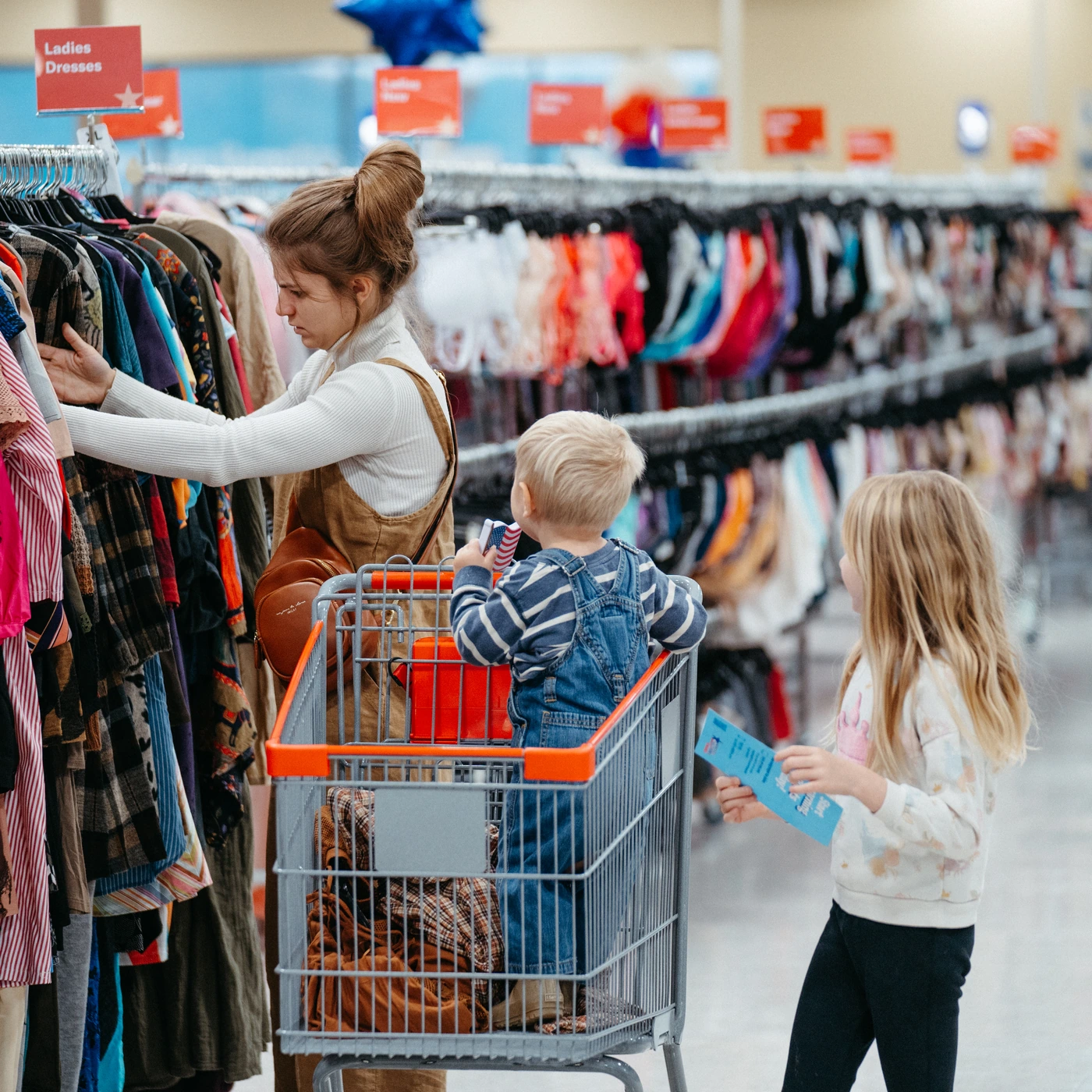 Family browsing clothing together at America’s Thrift Stores