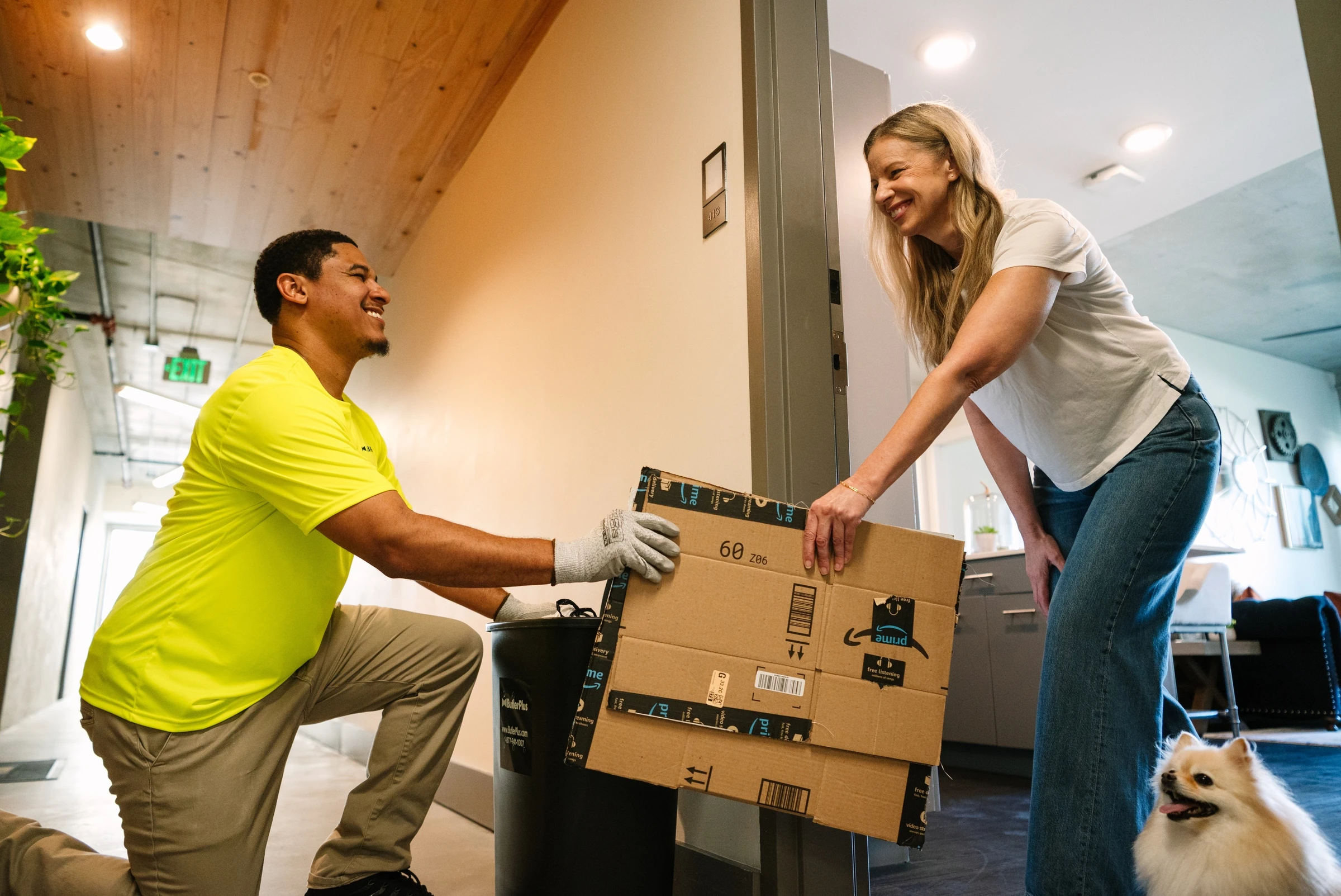 Butler Plus team member helping a resident with packages at her apartment