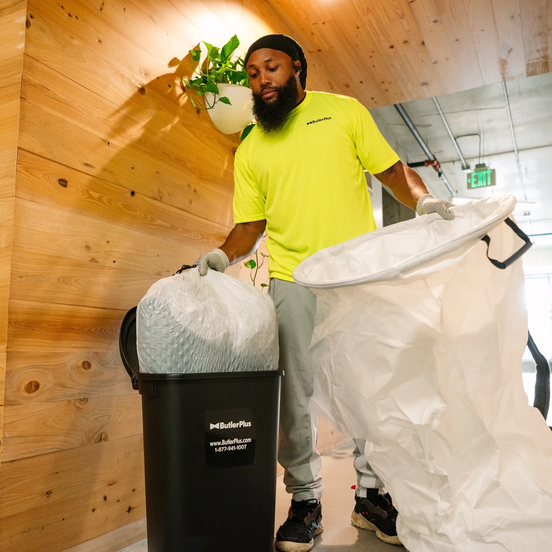 Butler Plus team member collecting doorstep waste inside an apartment community