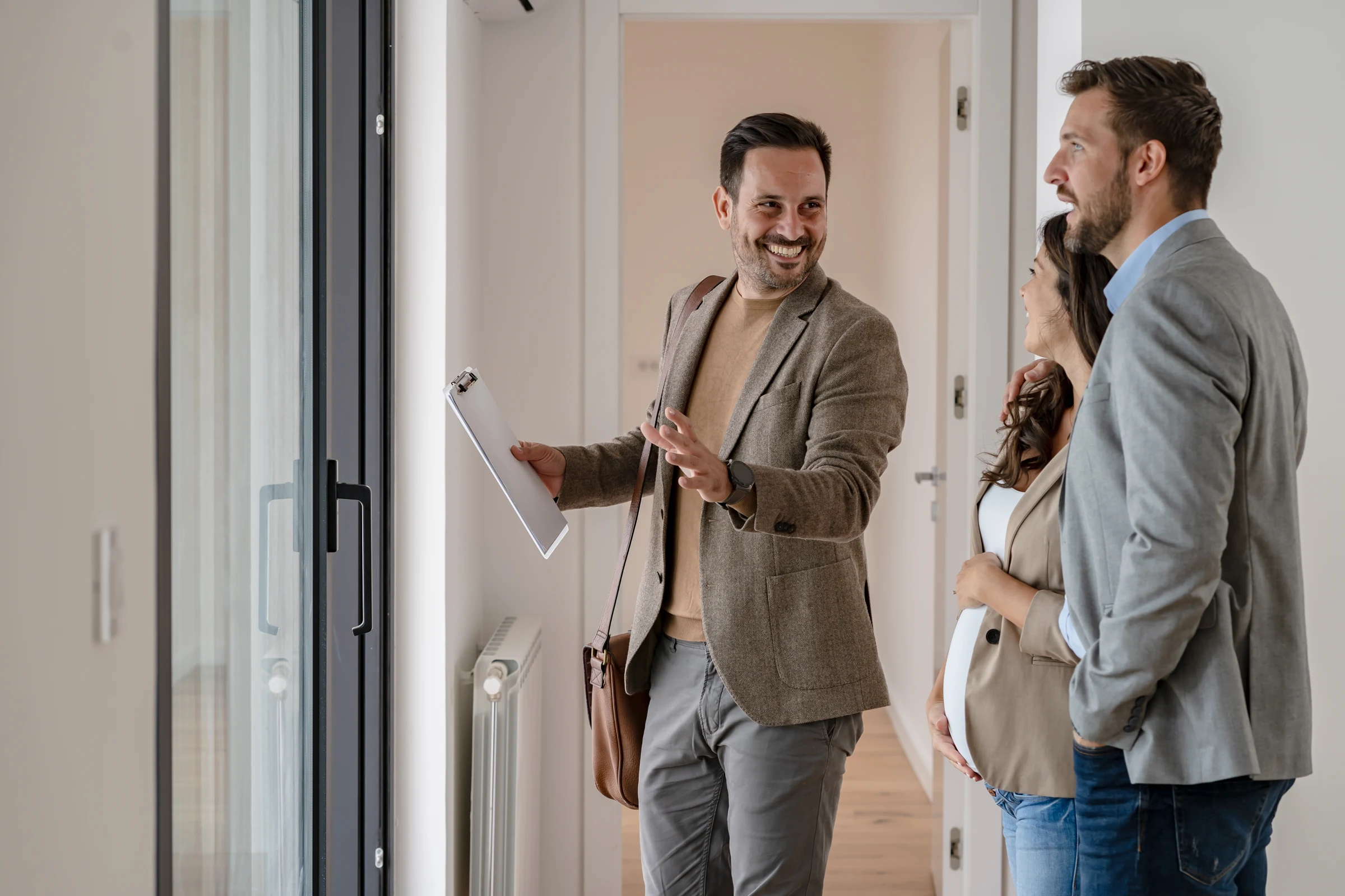 A consultant welcoming relocating employees during a home tour