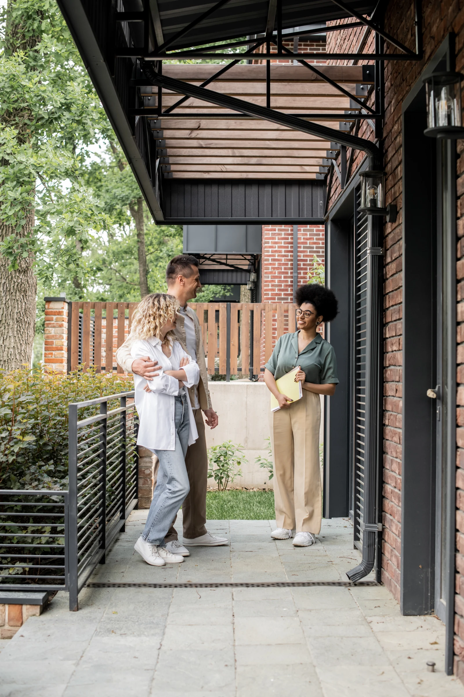 A family meeting a relocation consultant outside a home