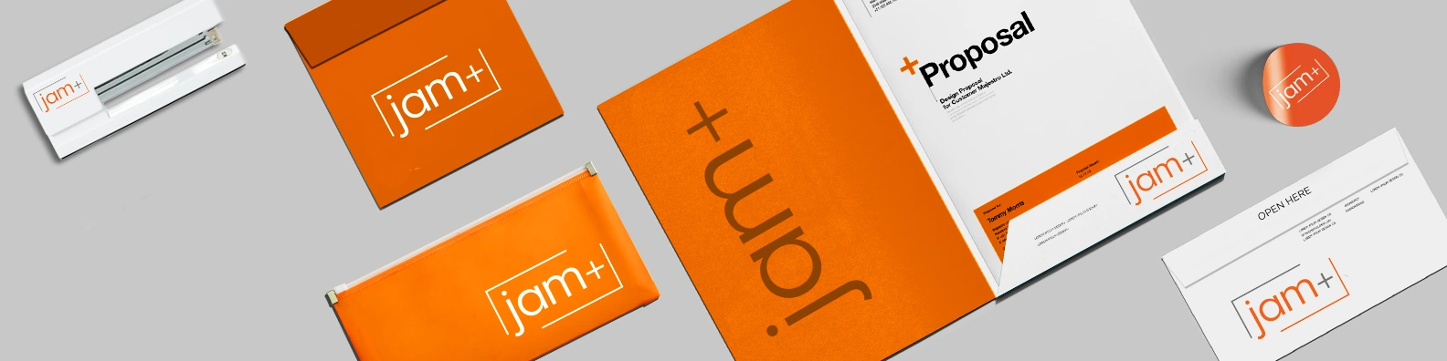 JAM+ branded orange stationery, printed folders and custom office products