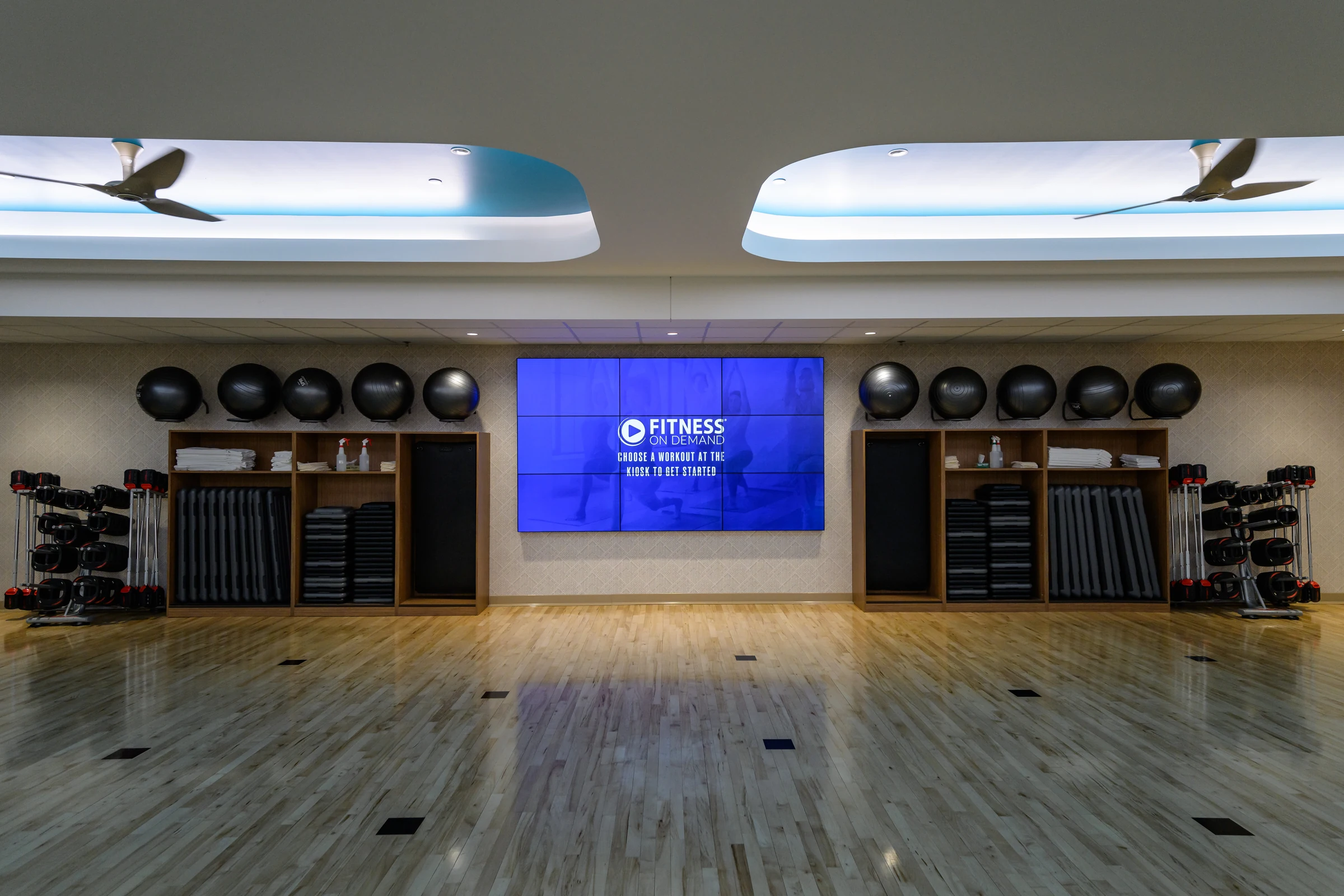 Fitness On Demand digital workout screen in a group exercise studio