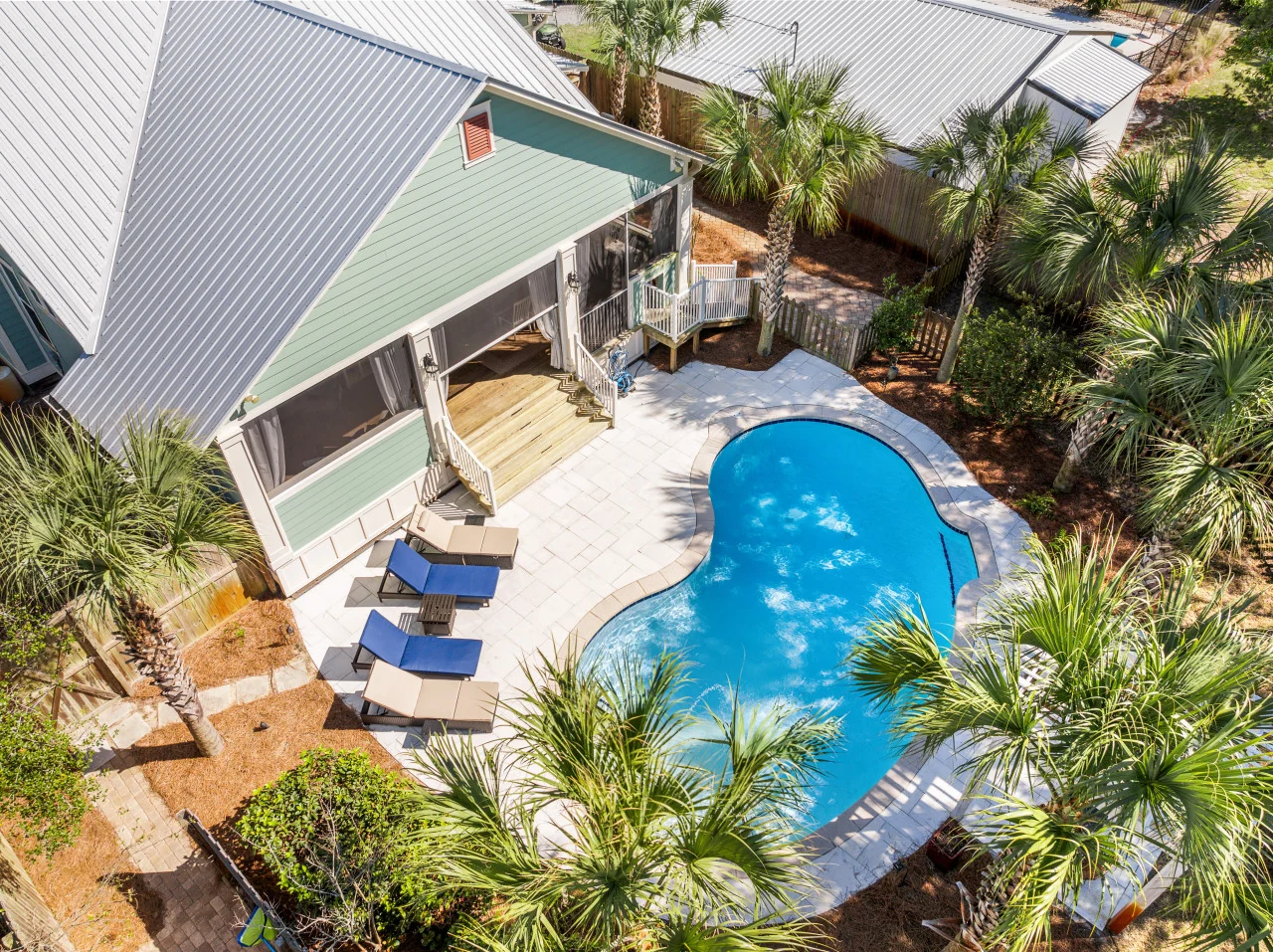Vacation rental home with a private pool and palm-lined outdoor space