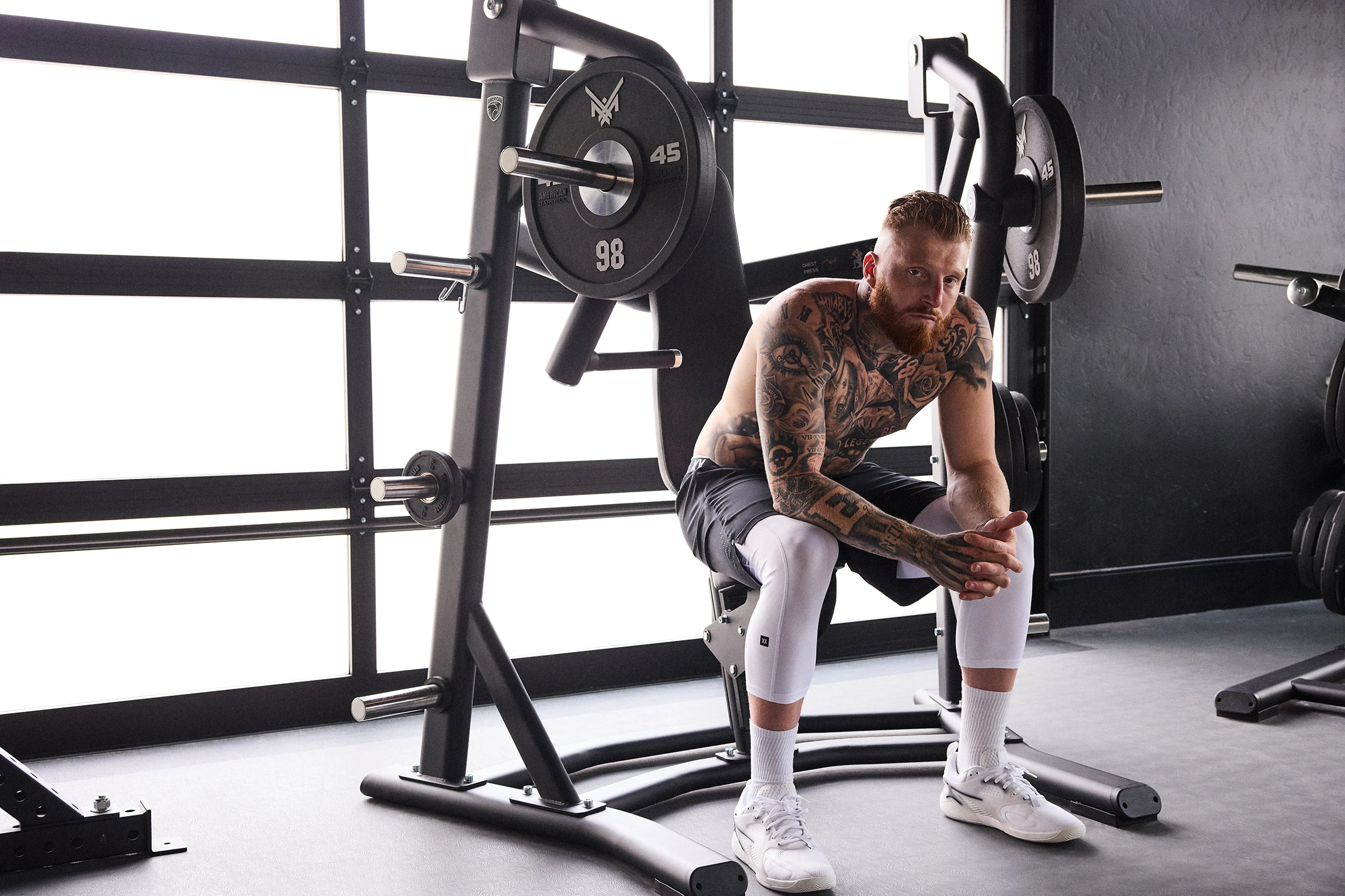SAXX athlete campaign photographed beside strength training equipment