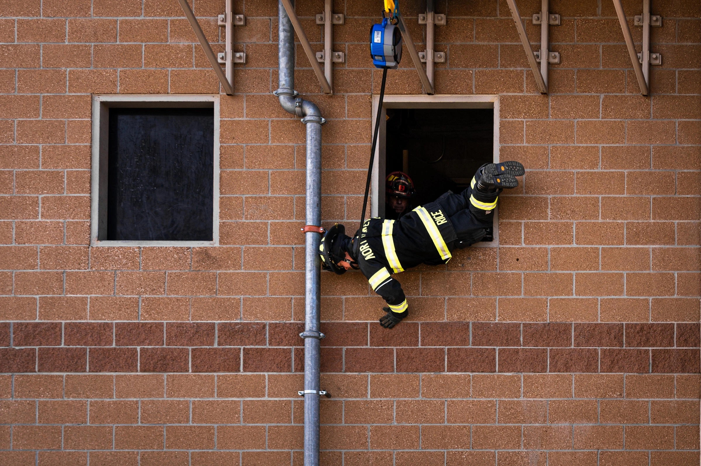 Firefighter using a TruBlue controlled descent system during training
