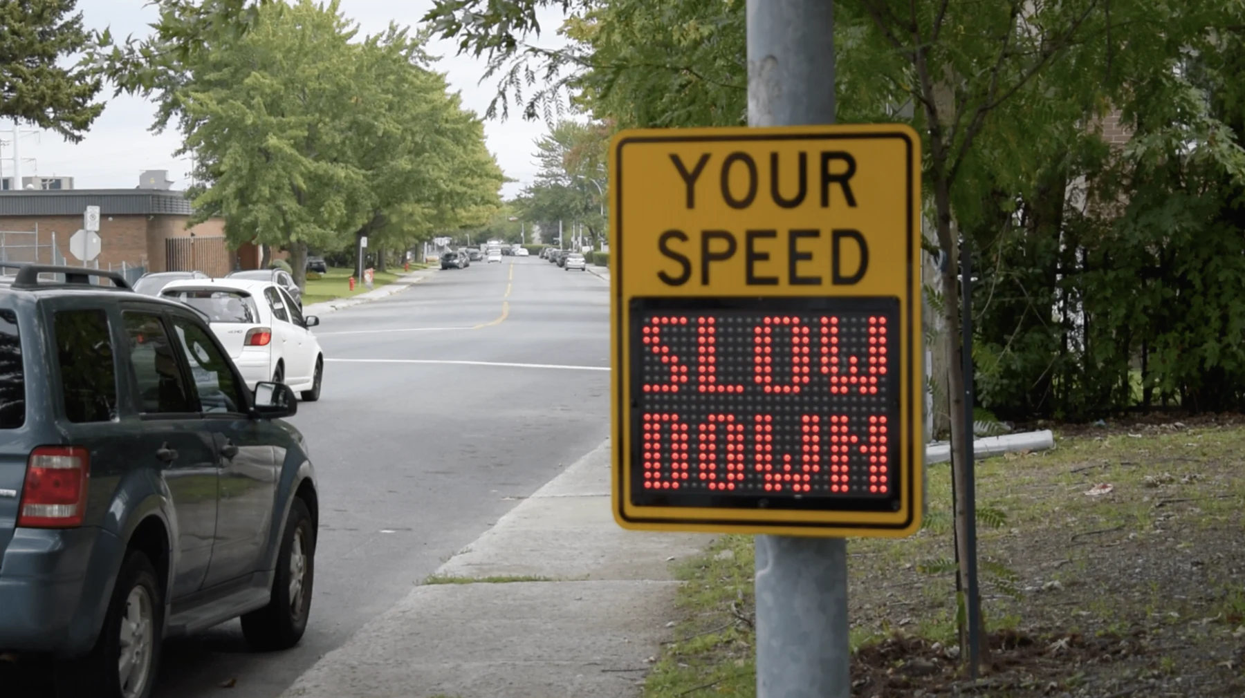 Traffic speed feedback sign beside a neighborhood road