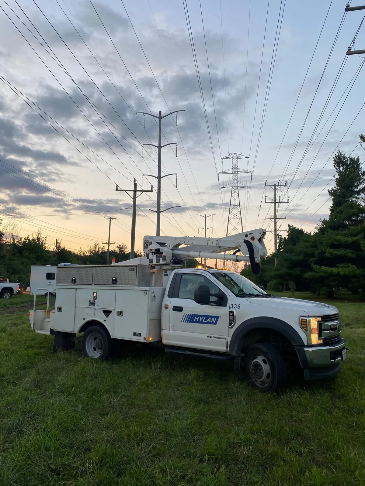 Hylan utility service vehicle beneath overhead power lines