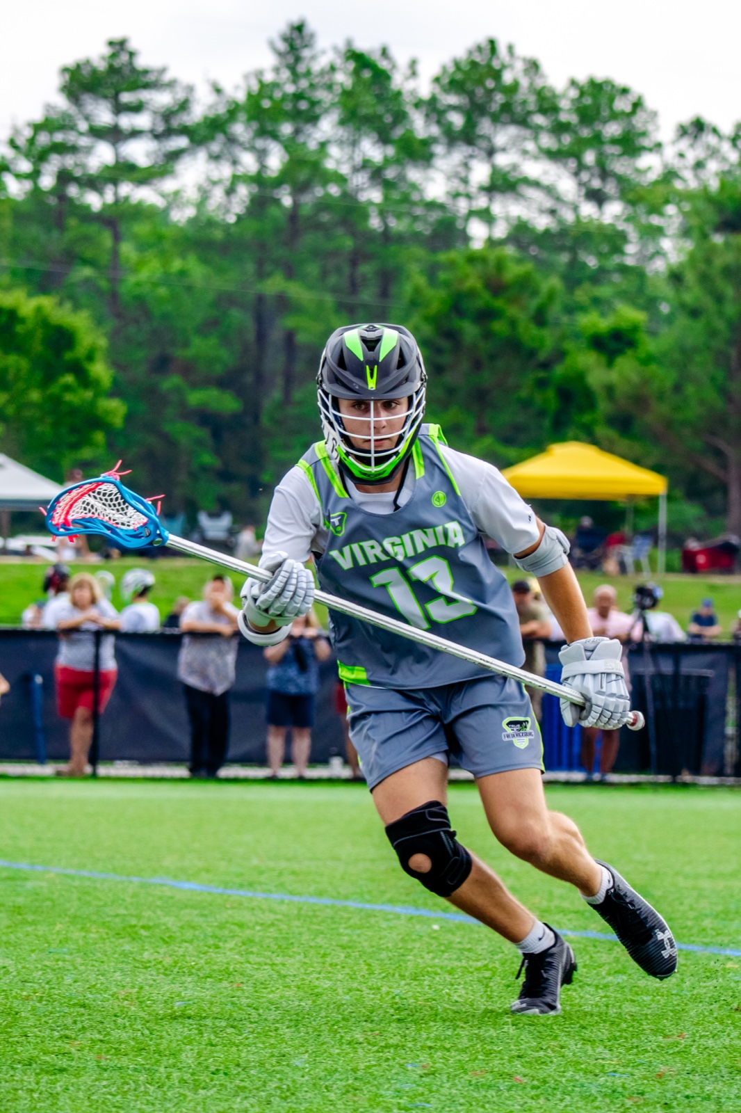 True Lacrosse player carrying the ball during a game